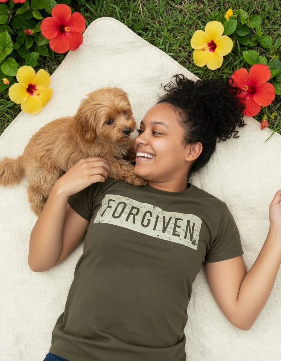Woman lying on a blanket with a small dog, surrounded by flowers
