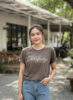 Woman wearing a 'Made to Worship' t-shirt outdoors