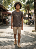 Young boy standing on a stone path with palm trees in the background