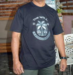 Person wearing a navy blue t-shirt with a palm tree design and text.