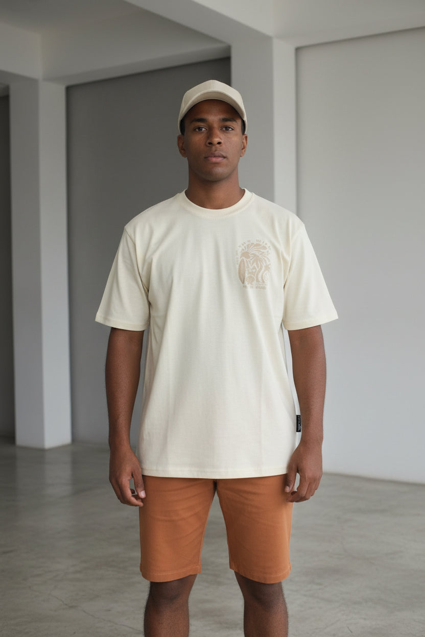 Man wearing a beige shirt and shorts standing 