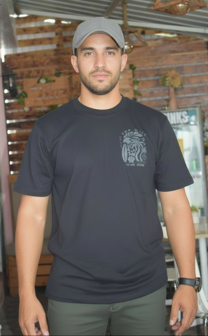 Man wearing a black t-shirt with a logo, standing indoors with a blurred background
