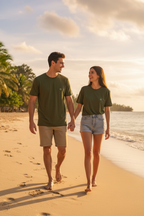 Couple in matching olive green logo tees walking on the beach