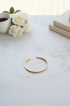 Gold bracelet flatlay on marble