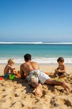 Man playing with children on beach