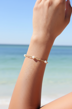Pearl Bracelet Against Sky and Ocean