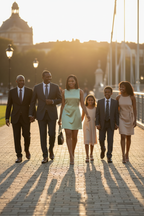 Woman in green dress walking with family - same model