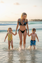Woman walking with children in shallow water